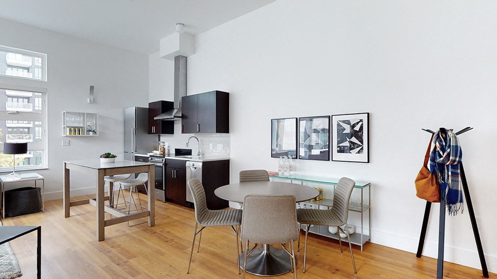 A modern kitchen with a dining table and chairs.
