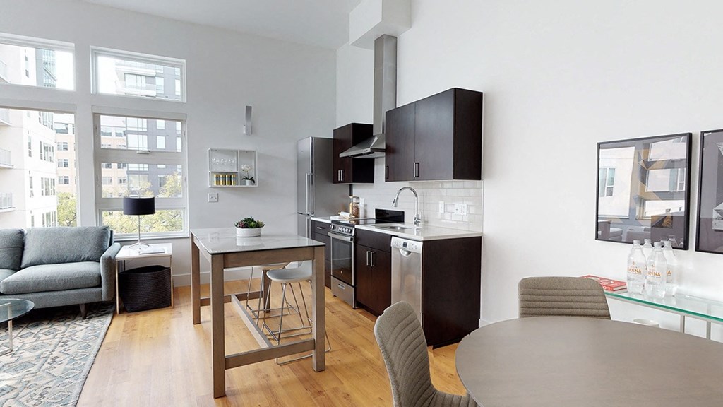 A modern kitchen with a dining table and chairs.