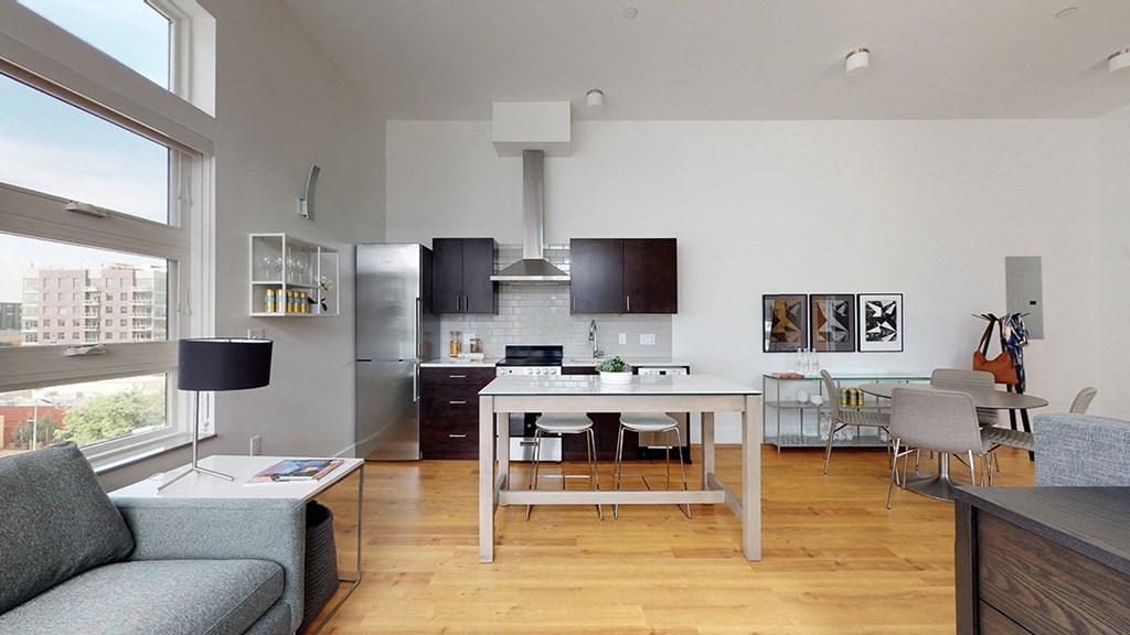 A modern kitchen with a dining table and chairs.