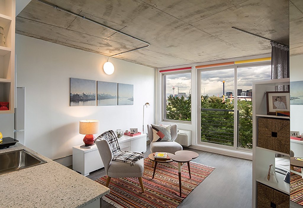 A modern kitchen with a dining table and chairs.