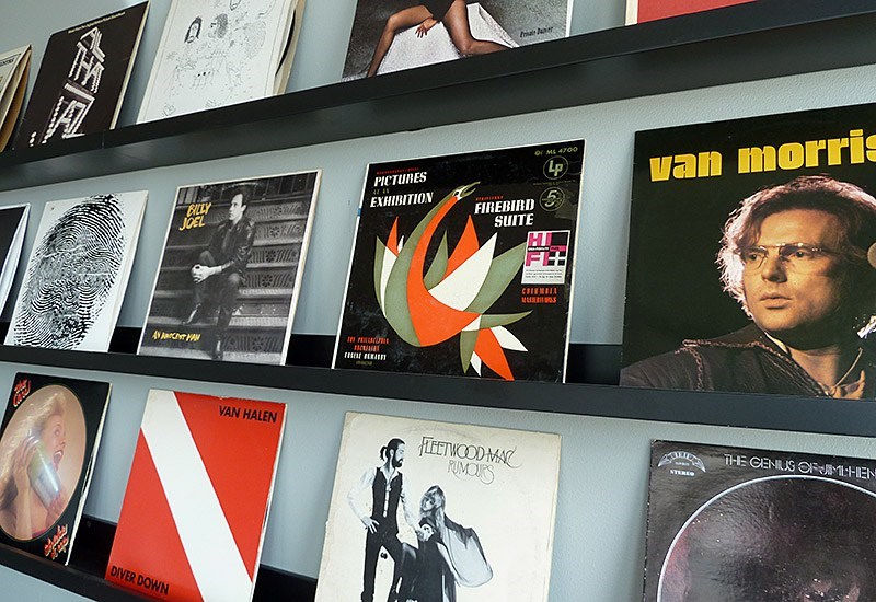 A wall of posters including one for Pink Floyd.