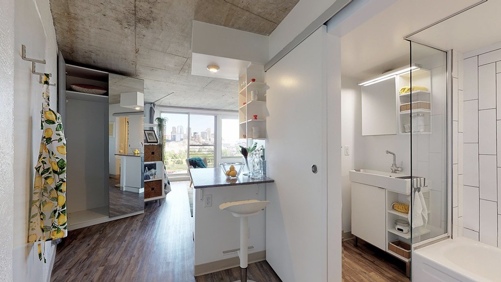 A bathroom with a white sink and a window.