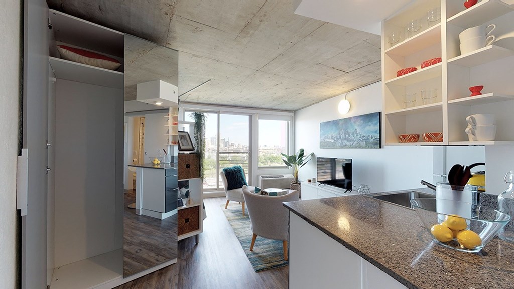 A kitchen with a counter top and a bowl of lemons on it.
