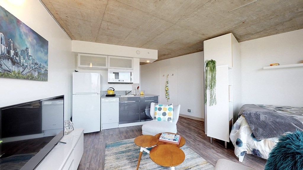 A modern living room with a fireplace and a painting on the wall.