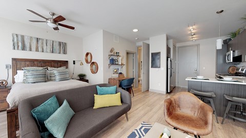 A living room with a grey couch and a brown chair.