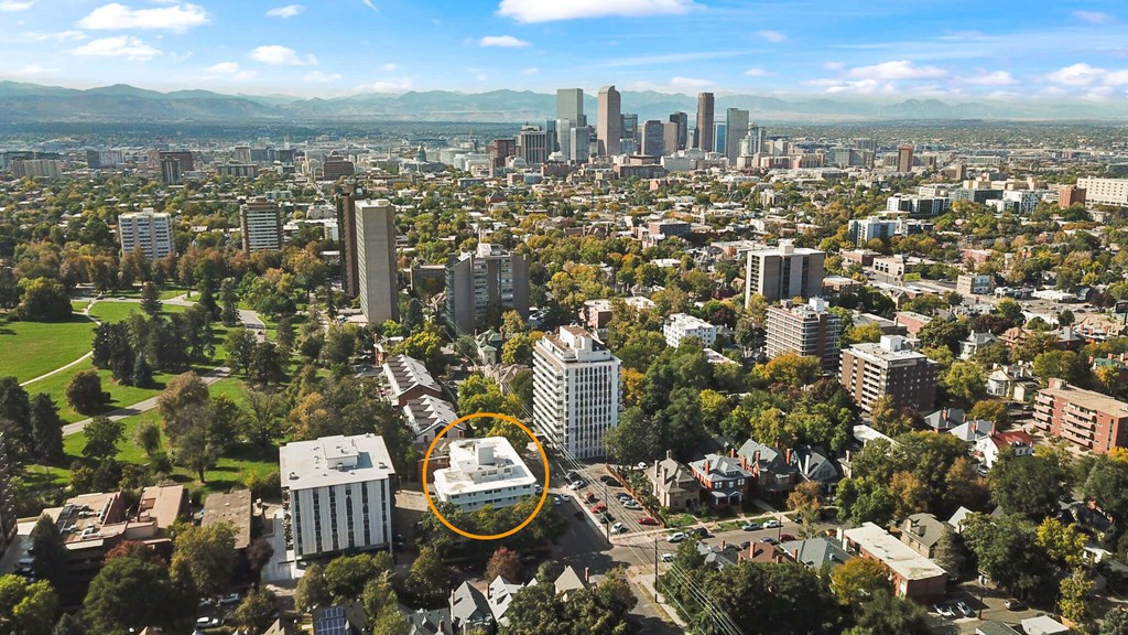 A cityscape with a large building circled in the middle.