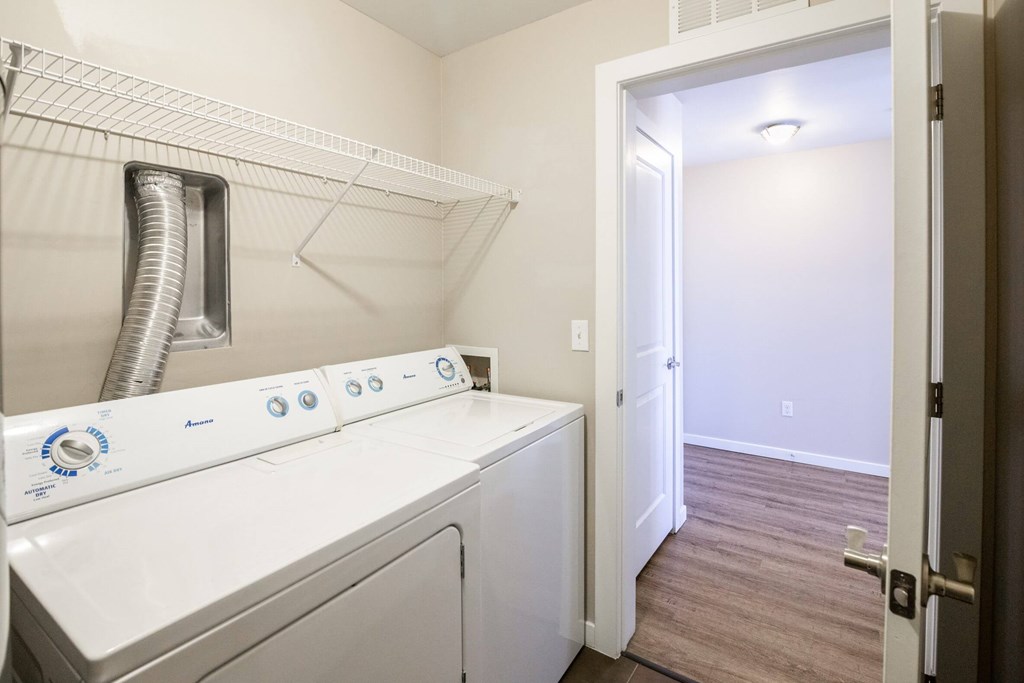 A white washer and dryer in a small laundry room.