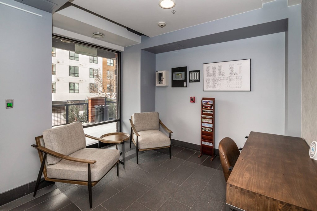 A waiting room with two chairs and a table.