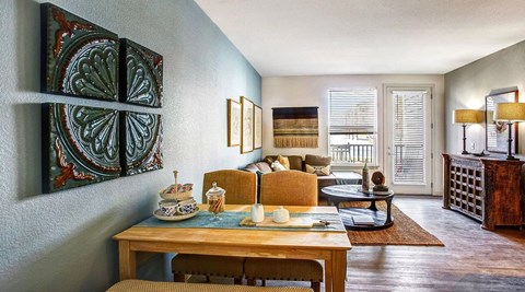 A dining room with a wooden table set for four.