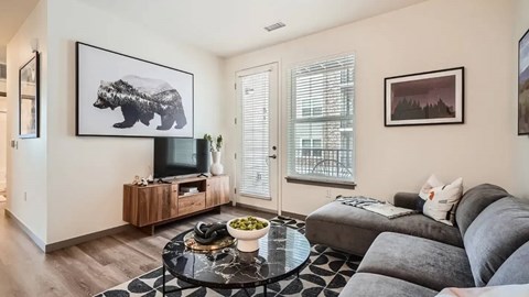 A living room with a bear picture on the wall.