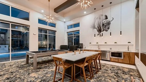 A modern dining room with a large buffalo head mounted on the wall.