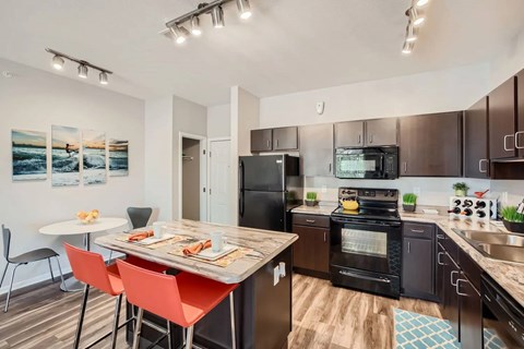 A modern kitchen with a dining table and chairs.