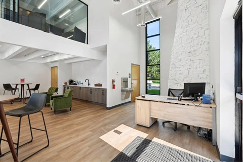 A modern office space with a wooden desk and chairs.