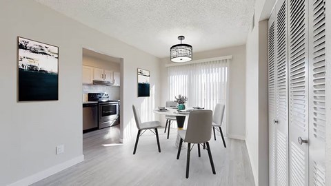 A modern dining room with a table set for four.
