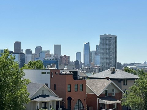 A cityscape with a mix of residential and commercial buildings.