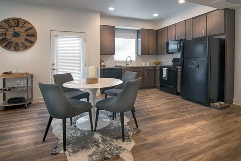 A modern kitchen with a table and chairs.