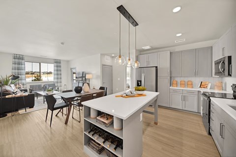 A modern kitchen with a dining table and chairs.
