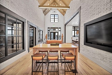 A modern dining room with a wooden table and chairs.