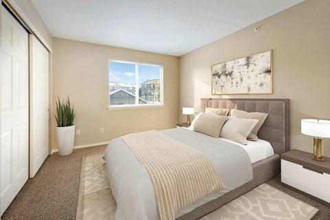A bedroom with a large bed and a view of a building outside the window.