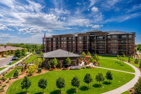 A large apartment complex with a flag on top of the building.