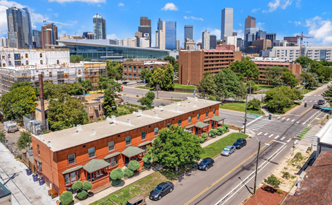 A cityscape with a red building in the foreground and a skyline in the background.