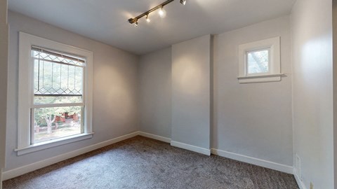 A room with a window and a small picture window.