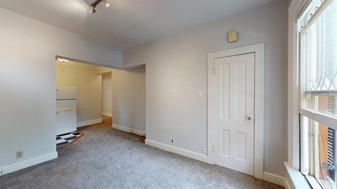 A white door is in a room with white walls.