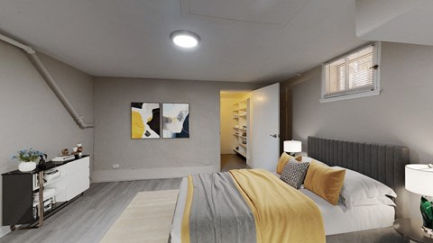 A bedroom with a bed, nightstand, and a painting on the wall.