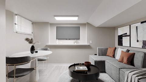 A modern living room with a grey sofa and a black coffee table.
