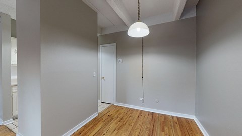A room with a wooden floor and a white door.