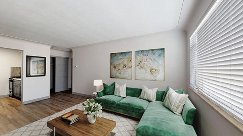A living room with a green couch and a coffee table.