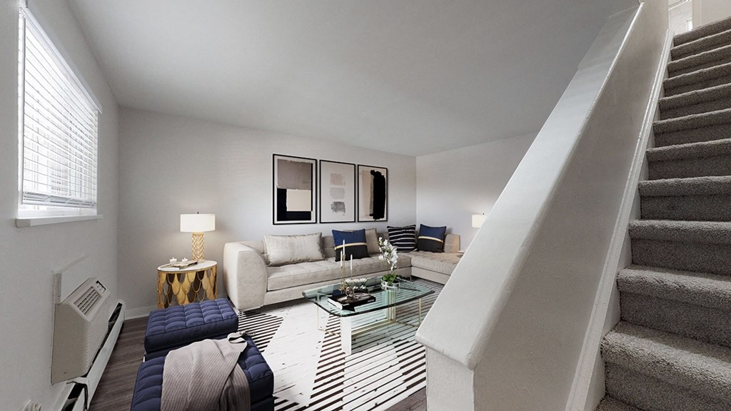 A living room with a staircase leading to the upper floor.