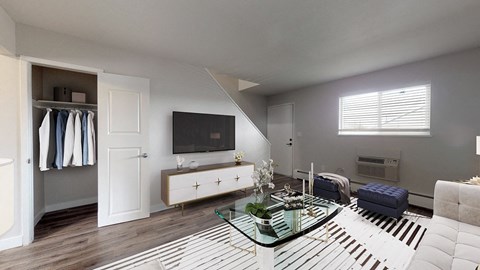 A modern living room with a glass coffee table and a television.