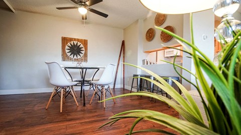 A dining room with a white table and chairs.