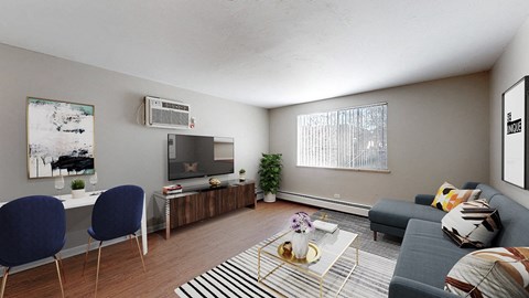 A living room with a grey couch, a coffee table, and a television.