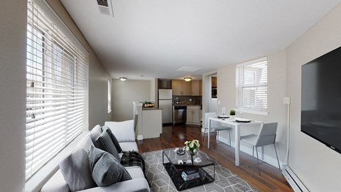 A living room with a grey couch and a coffee table in the middle.