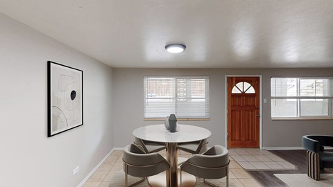 A dining room with a white table and chairs.
