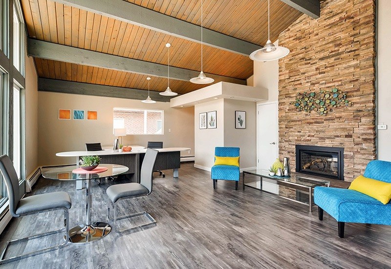 A modern living room with a fireplace and a dining table.