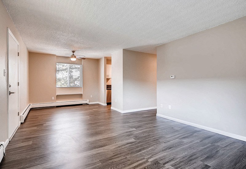 A room with wooden floors and white walls.