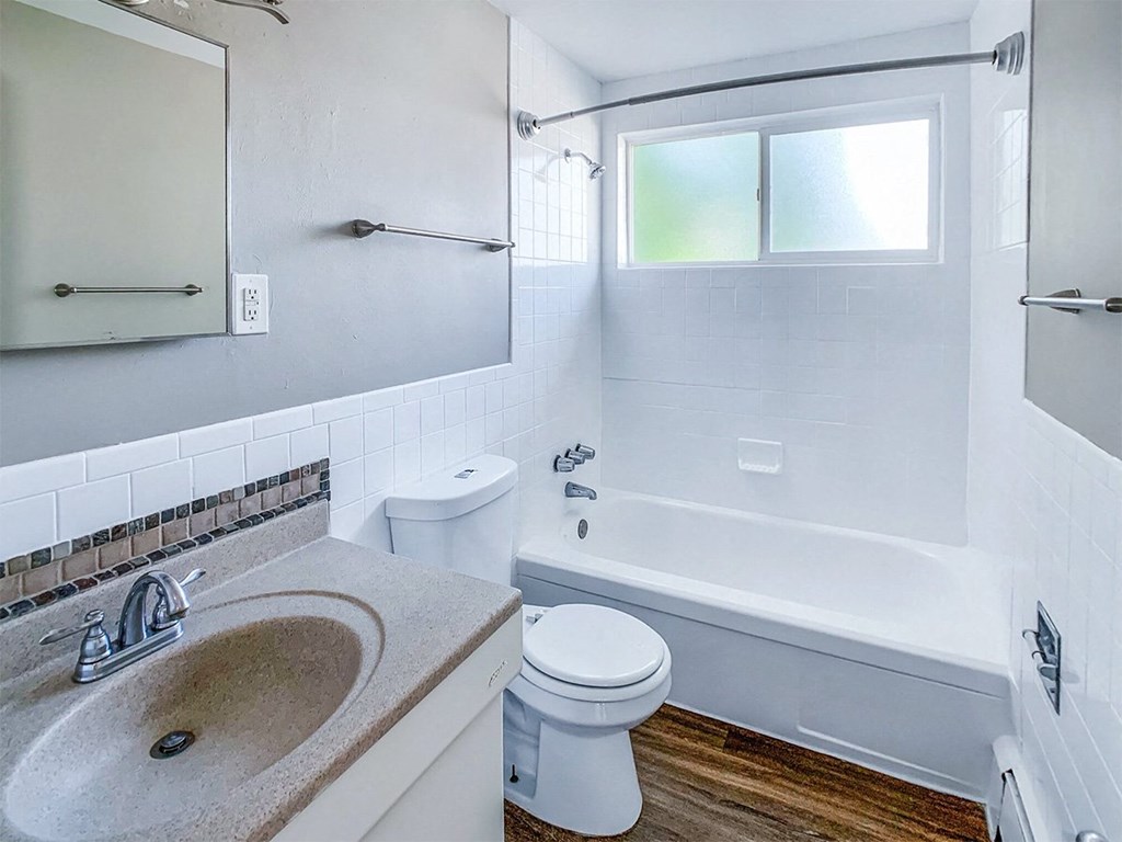 A white toilet sits next to a sink in a bathroom.