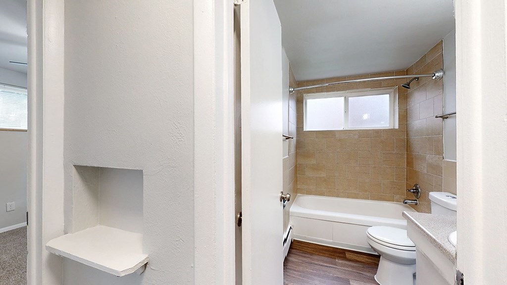 A bathroom with a toilet, sink, and bathtub.