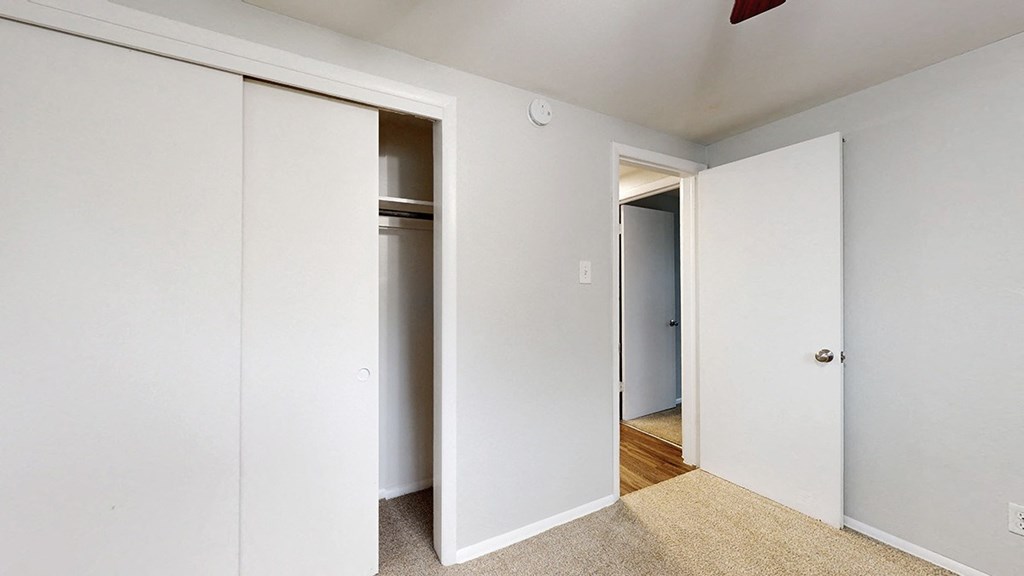 A white door is open to a hallway.