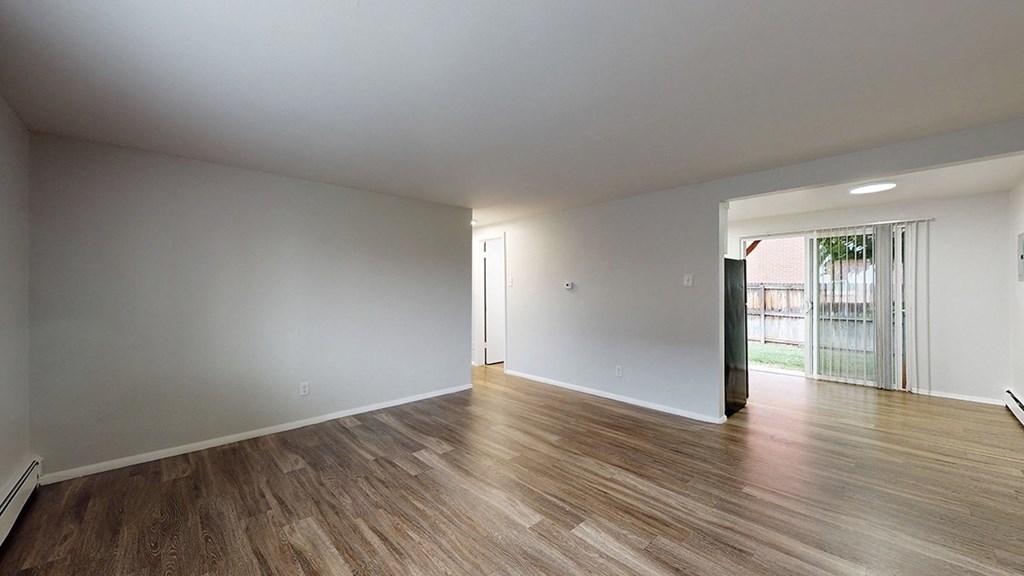 A room with wooden floors and white walls.