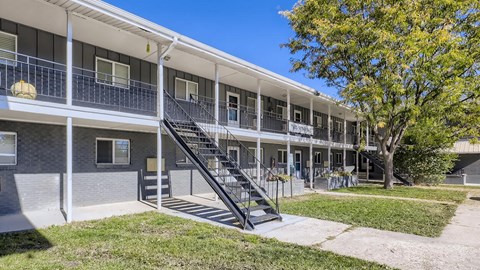 A multi-story apartment building with a staircase leading to the second floor.