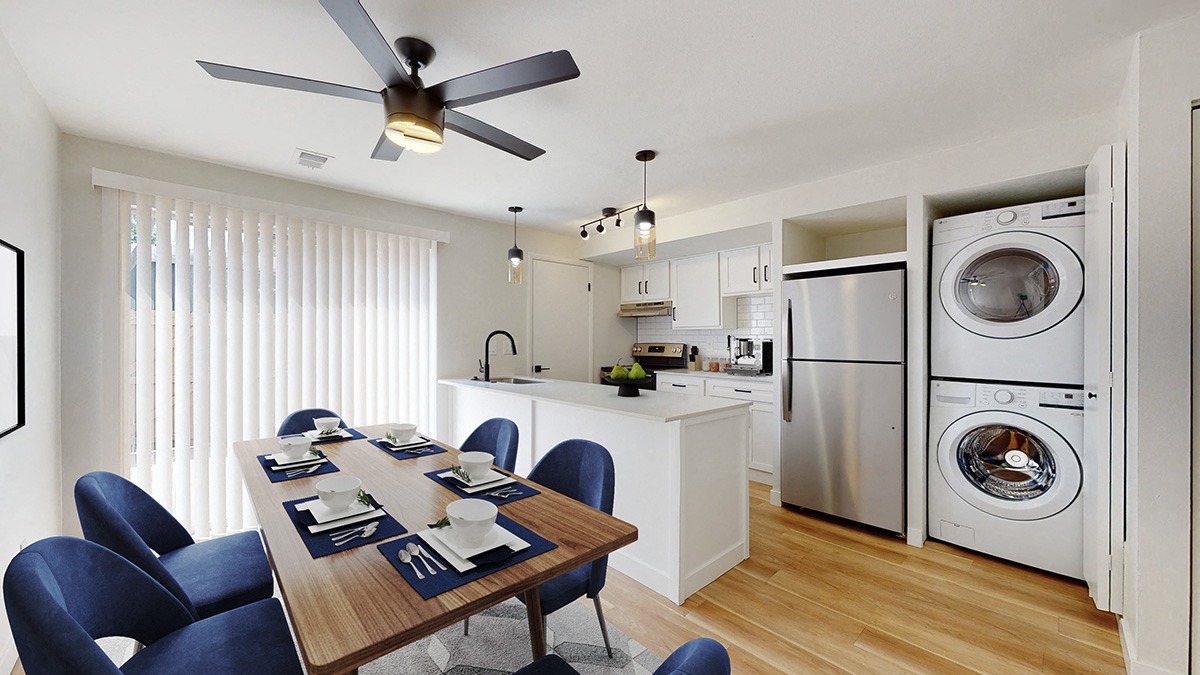 A modern kitchen with a dining table set for six.