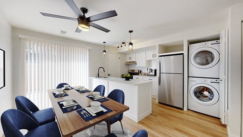 A modern kitchen with a dining table set for six.