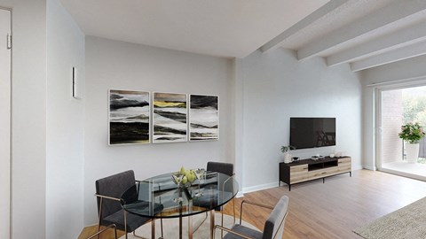 A modern dining room with a glass table and chairs.