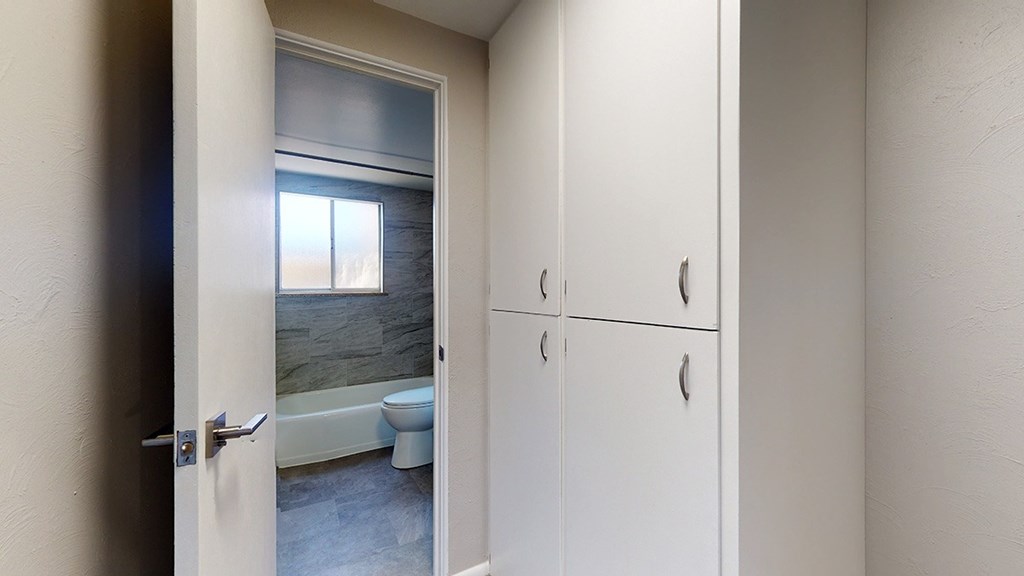 A bathroom with a tub, toilet and sink.