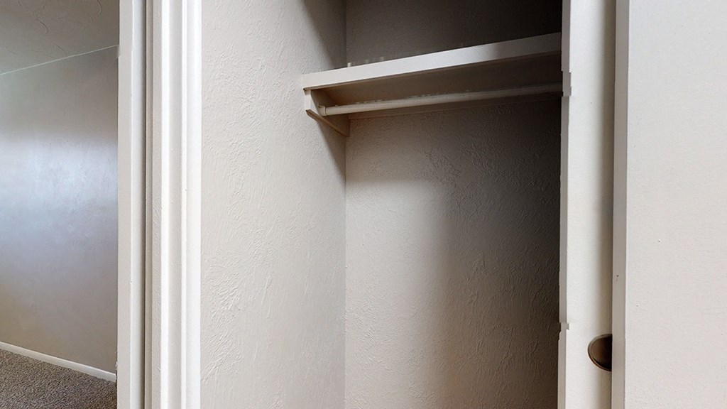 A white door with a shelf on the inside.