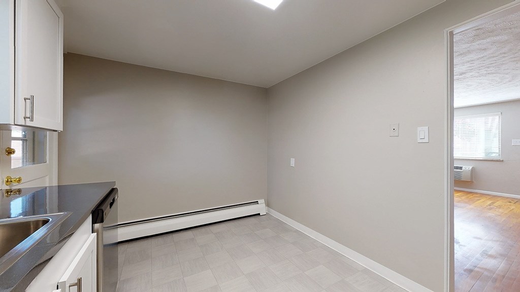 A kitchen with a sink and a window.